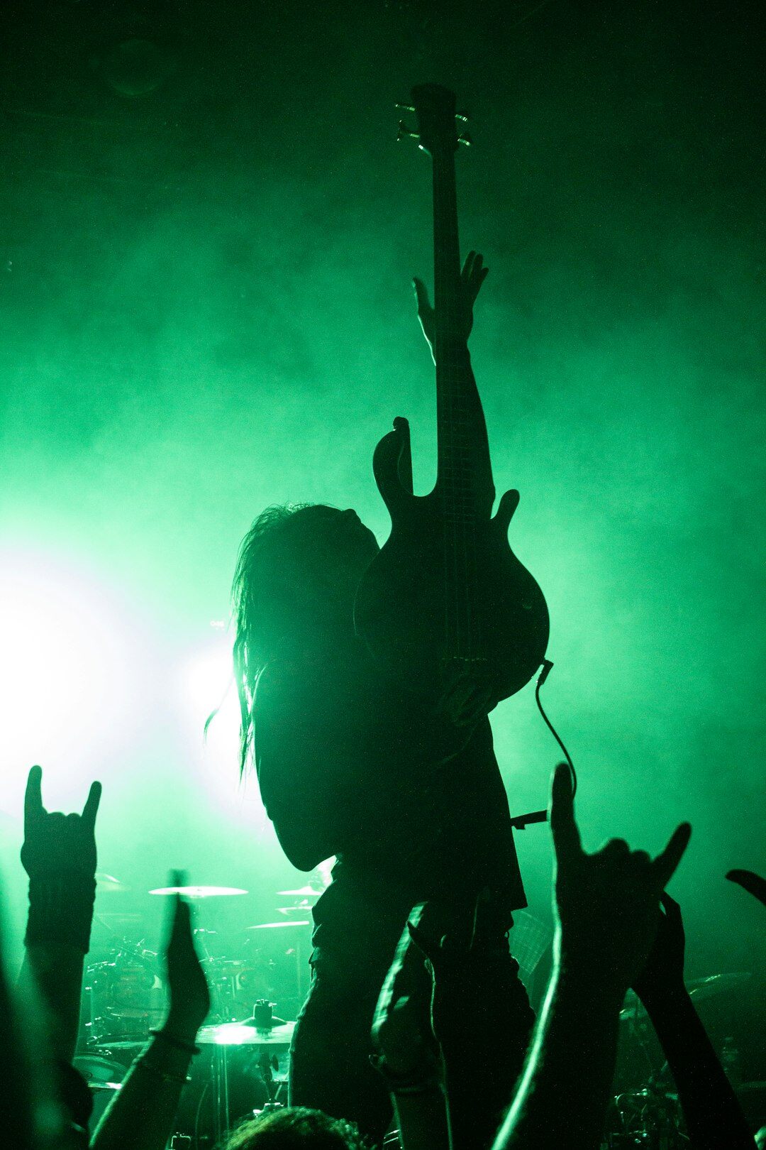 Musician performing on stage with concert lights